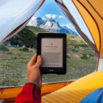 man with kindle in tent