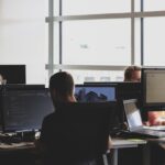 Office firm with employees using computers
