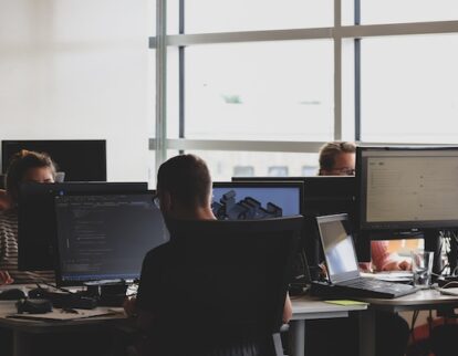 Office firm with employees using computers